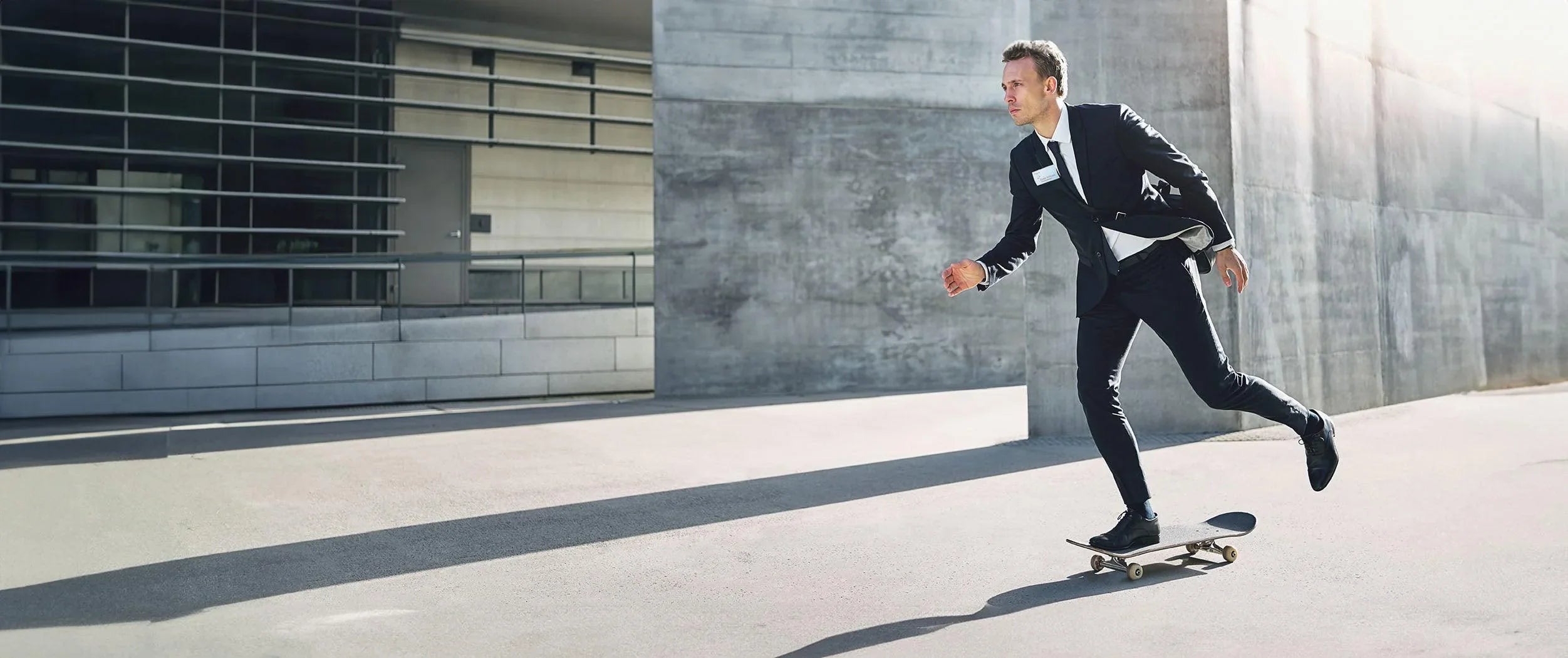 Man skating in a suit with his Durable Name Badge showing
