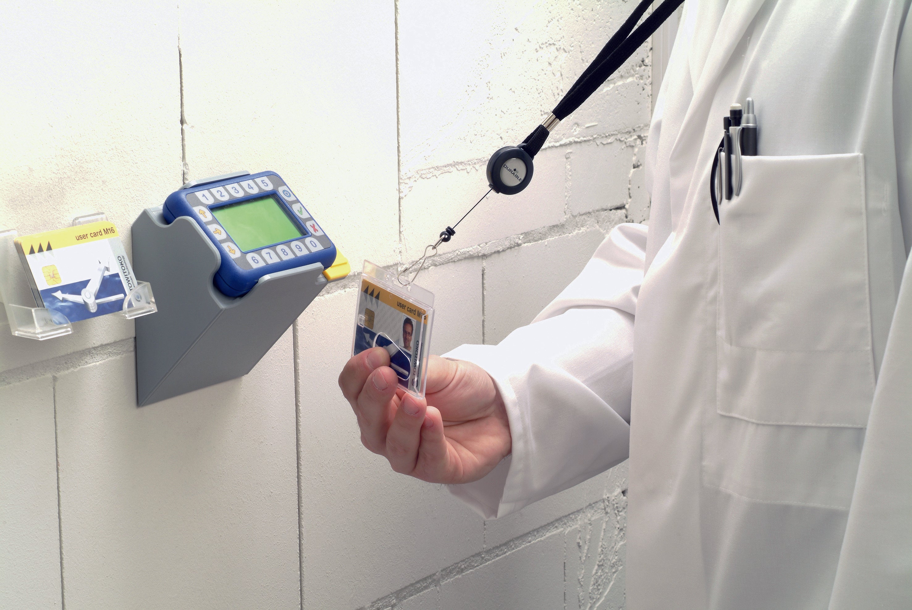 Doctor using an ID badge on a clock in door system