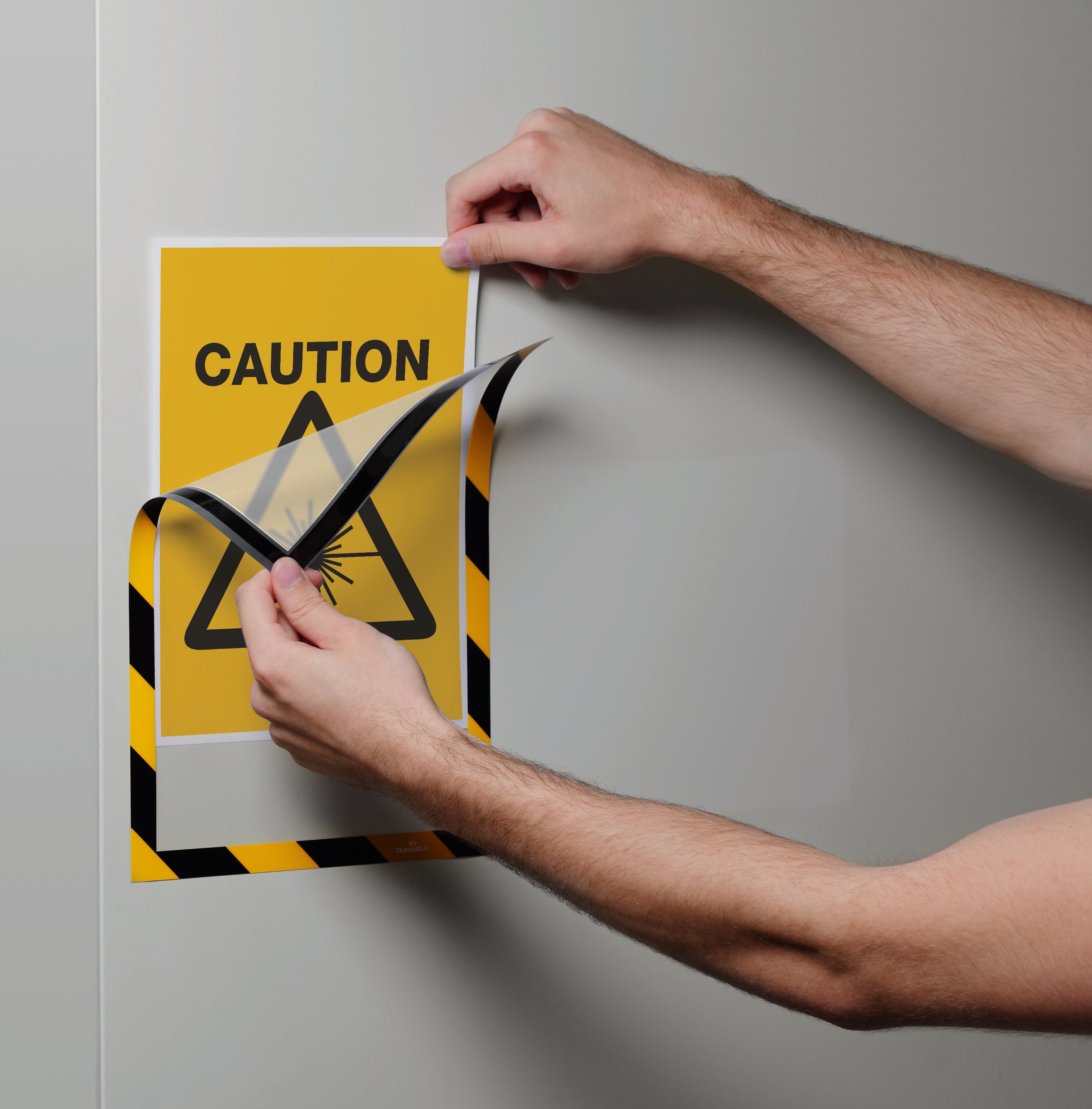 Duraframe Security Infoframe with caution sign on metal panel