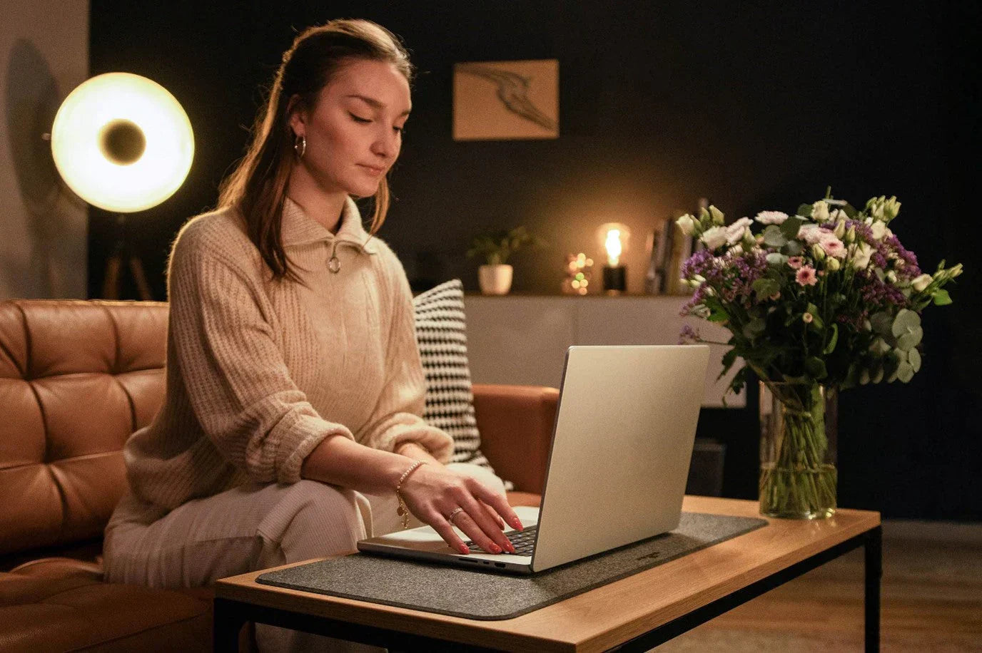Woman working on a laptop on a Durable Felt Effect Desk Mat